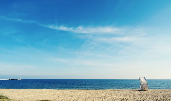 Peaceful beach with clear blue sky, ocean horizon, and sandy shoreline. Perfect for summer relaxation.
