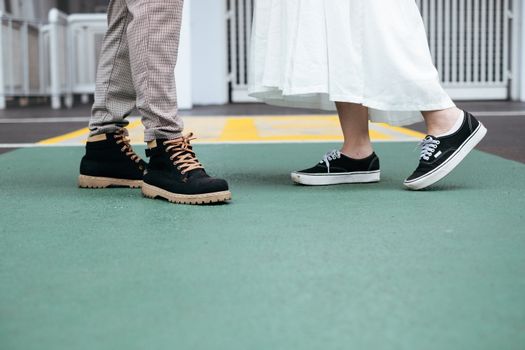 Close-up of trendy shoes on concrete. Urban fashion vibe.