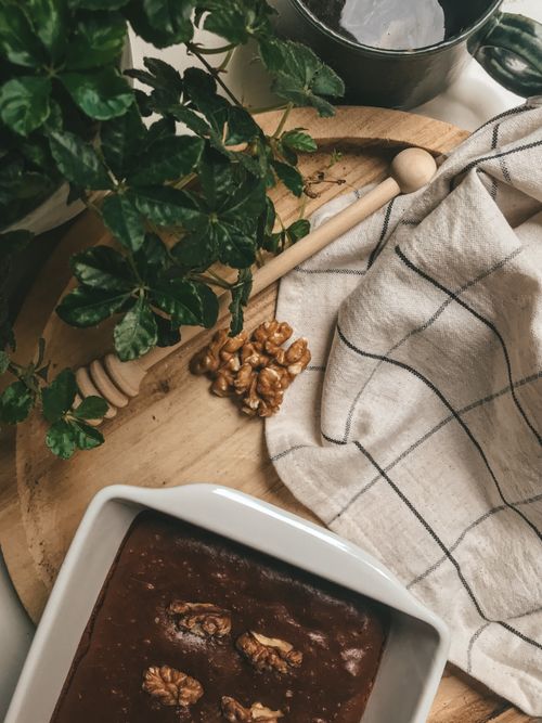 Free Delicious homemade chocolate walnut brownie on a cutting board with a rustic kitchen setting. Stock Photo