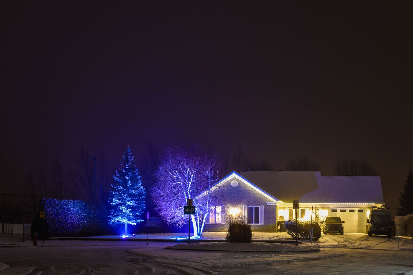 House exterior glowing with warm lights at night