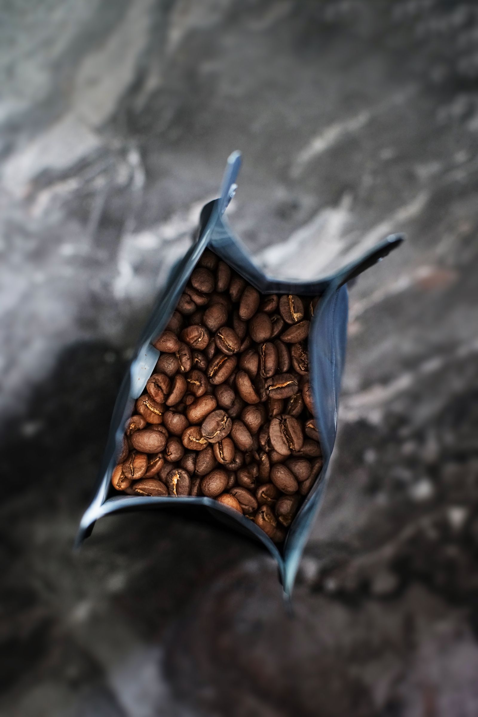 An open bag of freshly roasted beans on the packing bench
