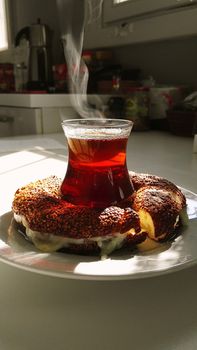A traditional Turkish tea served with simit on a sunny kitchen table in Kayseri, Turkey, capturing a warm ambiance.