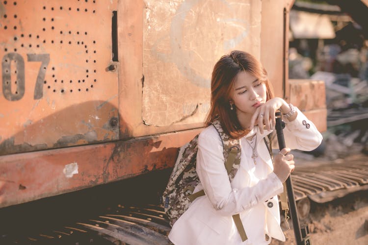 Woman In White Blazer Standing Beside The Bulldozer