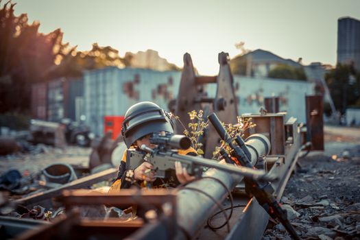 Person with helmet aiming toy gun in urban setting. Conceptual scene with dramatic effect.
