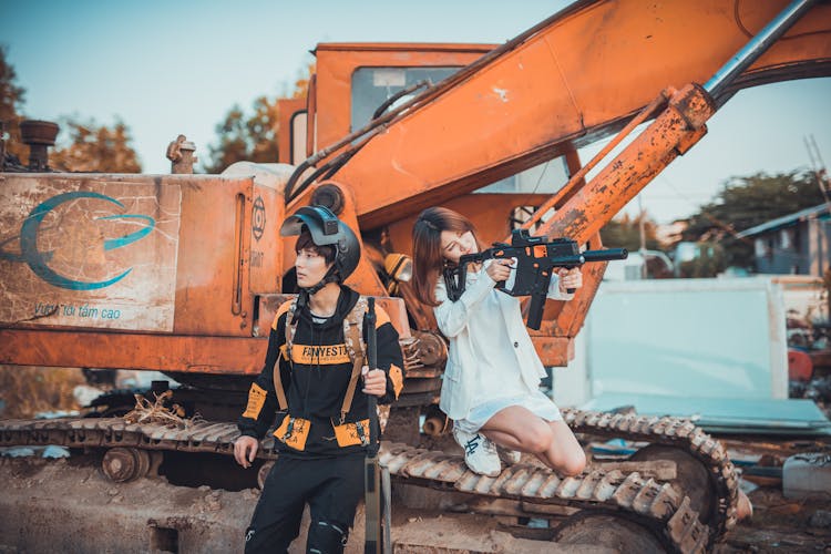 A Man And Woman Holding Firearms