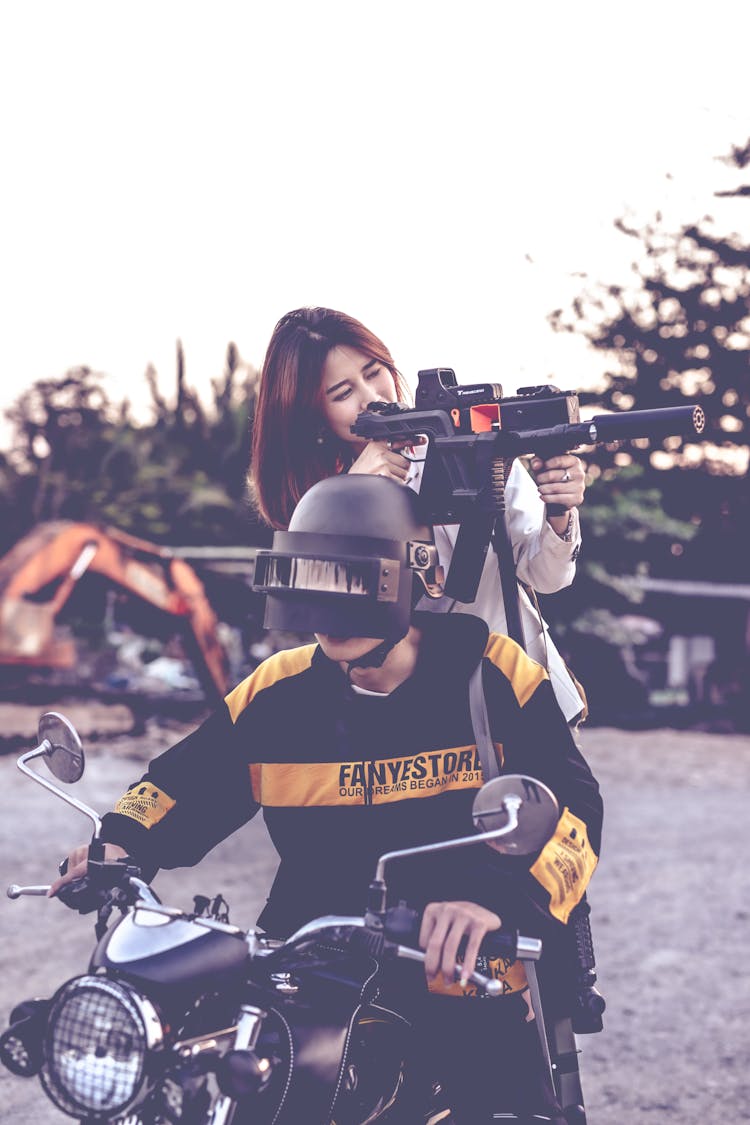 Woman Filming With Man Riding Motorcycle