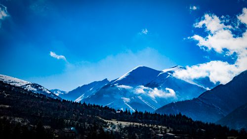 Free Breathtaking view of snow-covered mountains under a bright blue sky in Visso, Italy. Stock Photo