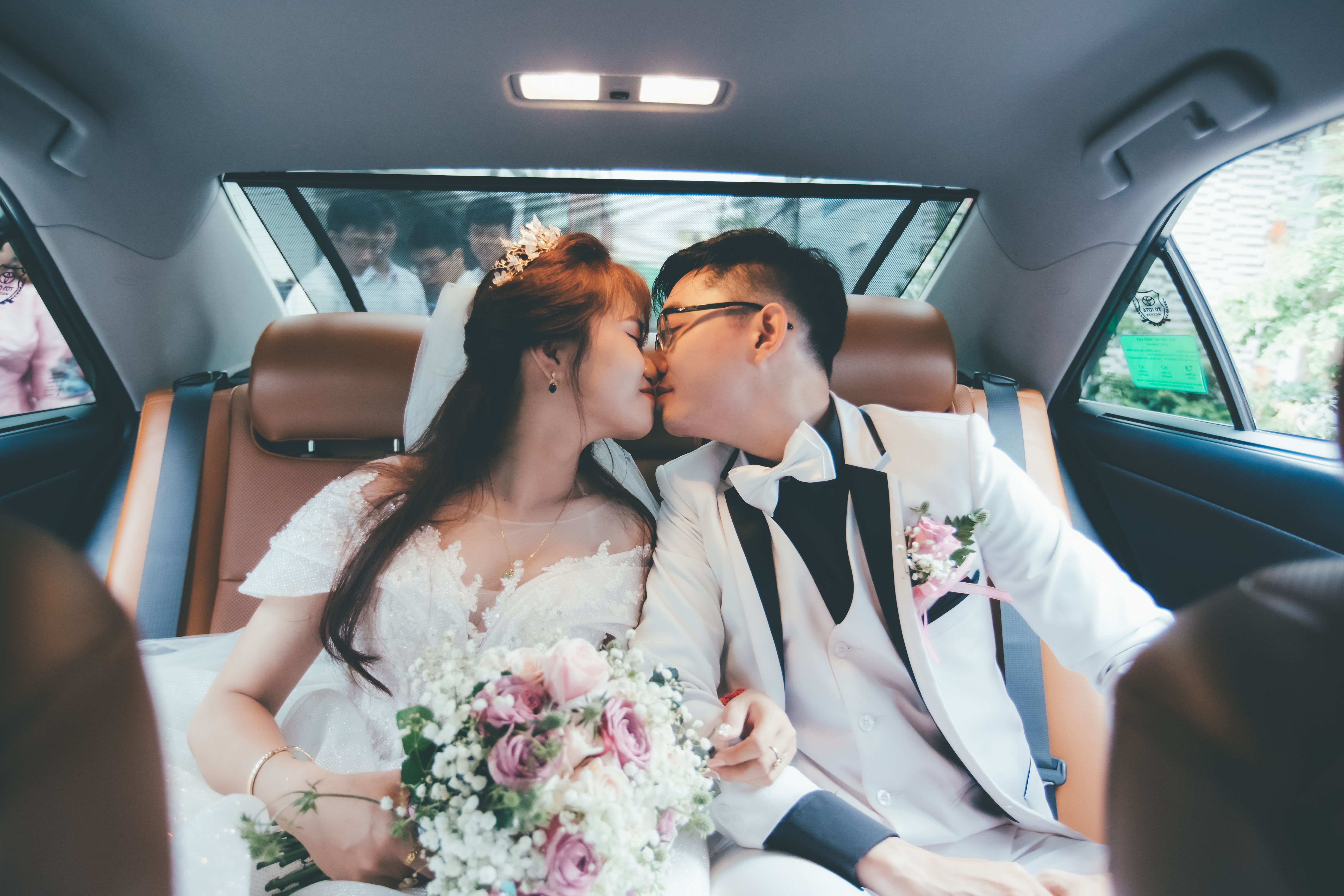 Bride and groom sharing their first kiss at the ceremony