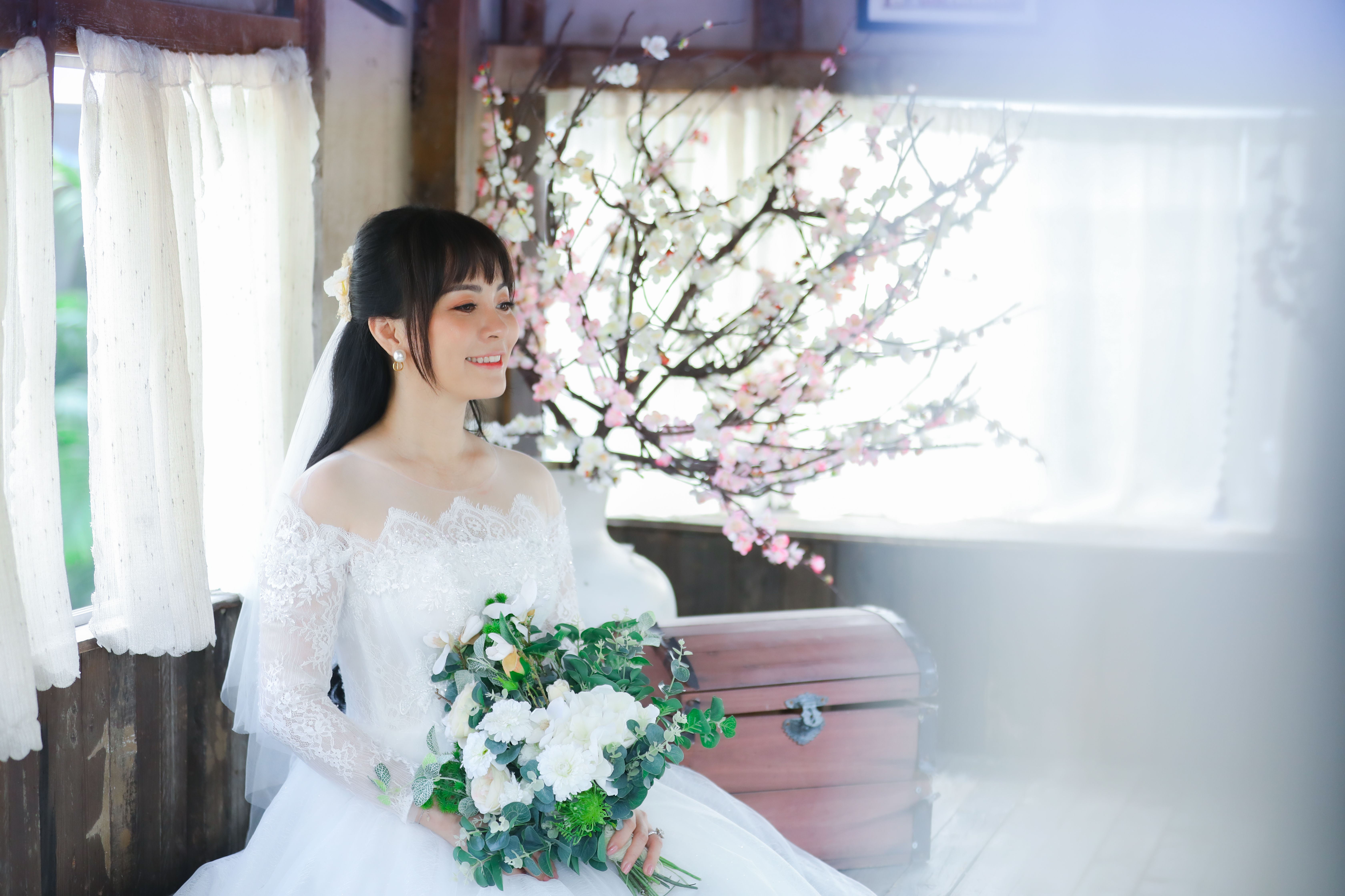 Woman in White Dress Holding Bouquet of Flowers · Free Stock Photo