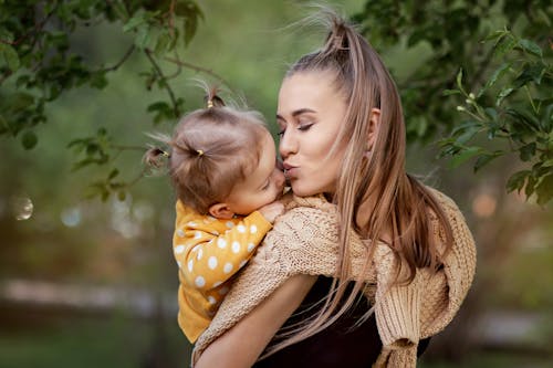 Mother Kissing Her Daughter