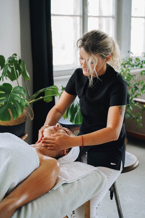 A Masseuse Massaging a Client