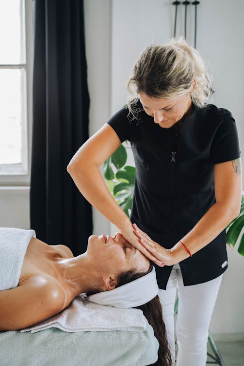 A Masseuse Massaging a Client