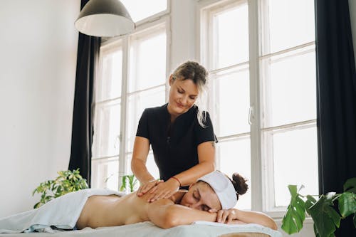 A Masseuse Massaging a Client