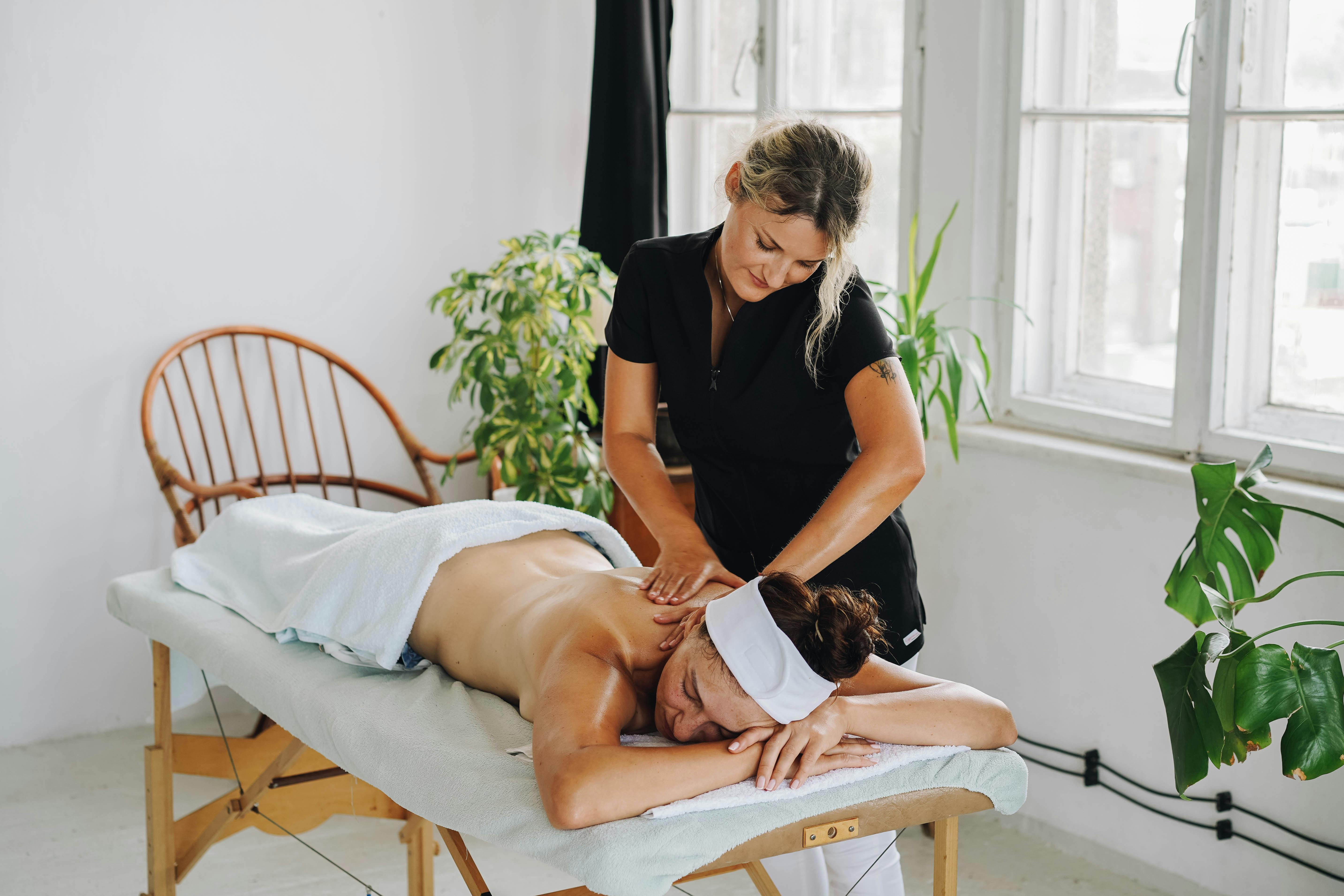 topless woman getting a back massage