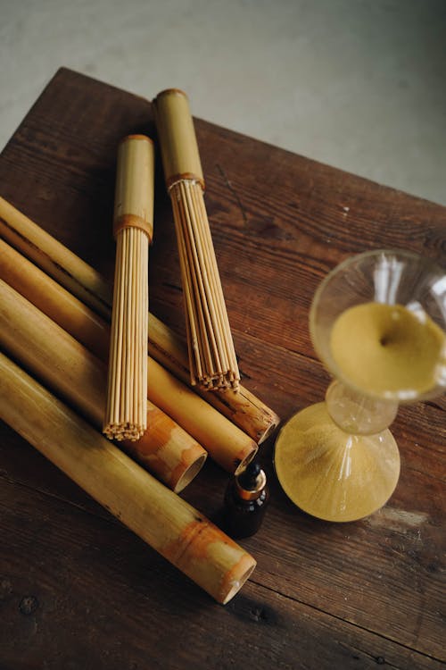 A Massage Oil beside Wooden Sticks