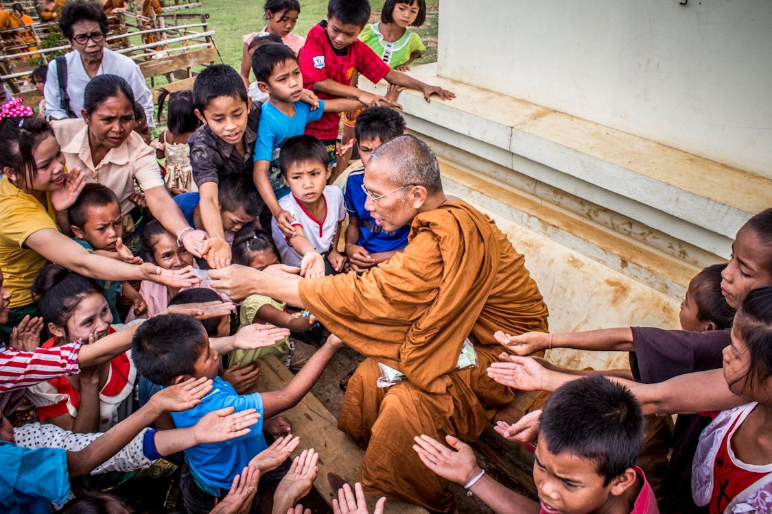 Free Monk Surrounded by Children Stock Photo
