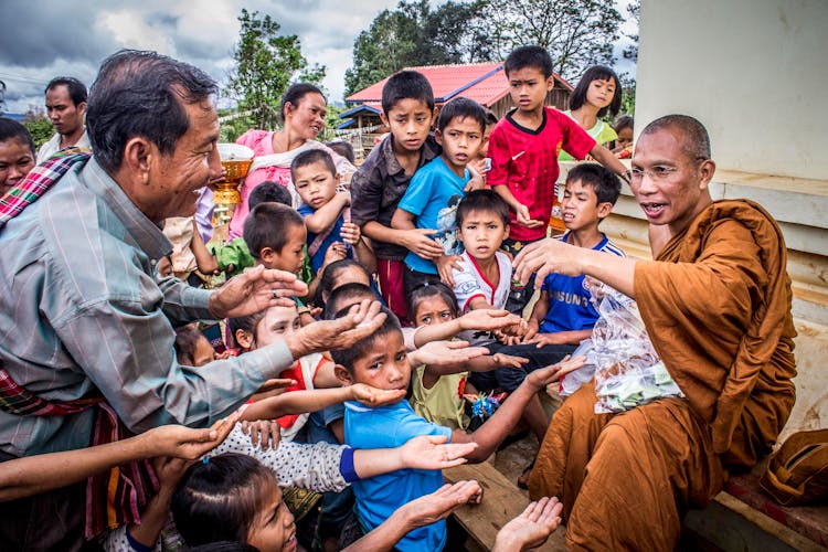 Group Of People Begging On Monk