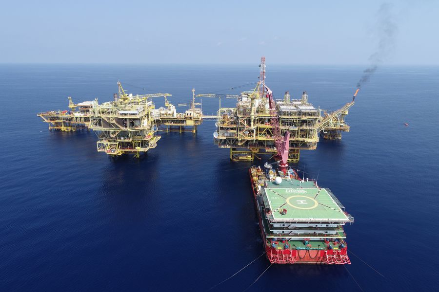 Aerial view of offshore oil platforms in calm water