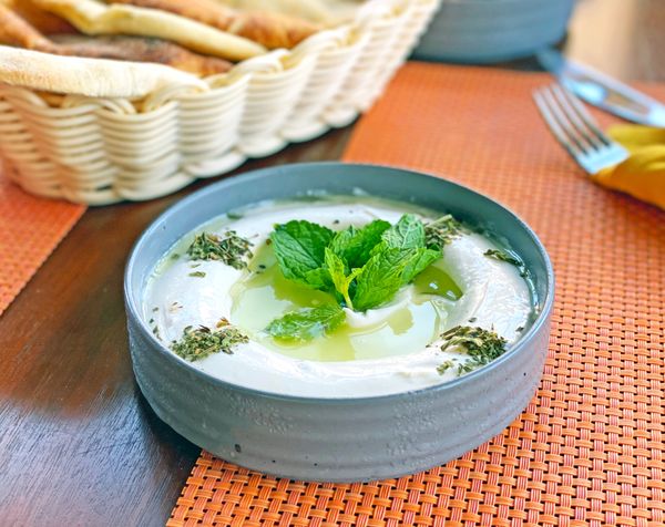 Herb dip garnished with mint beside flatbread — photo by Shameel mukkath on Pexels