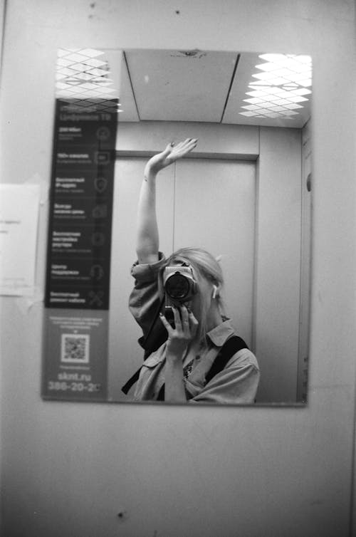 Woman Taking Picture In Front of a Mirror