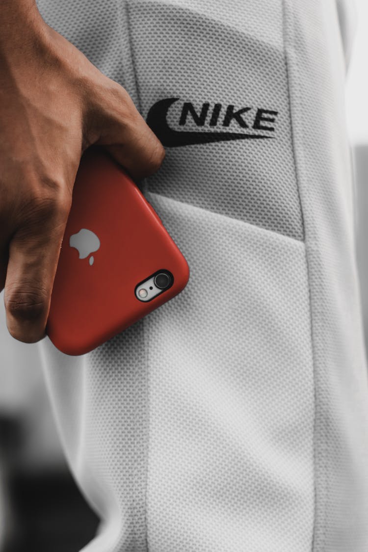 Person Wearing Nike Shorts Holding An Iphone 6 