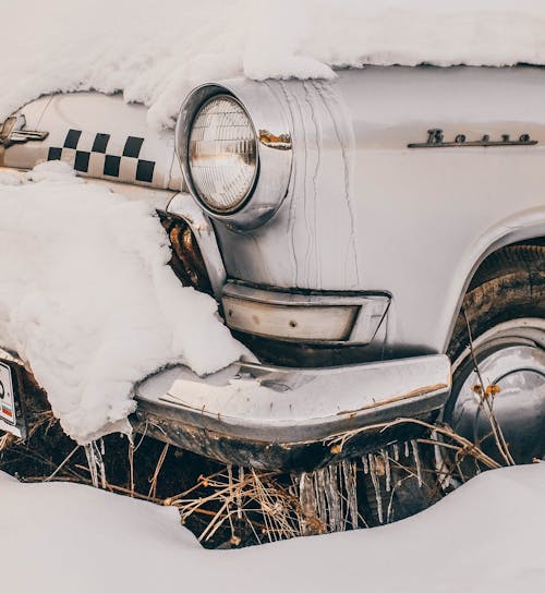 Close-Up Photography of Vintage Car Covered With Snow