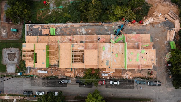 Aerial shot of a construction site in Chattanooga, showcasing wooden framework and heavy machinery.