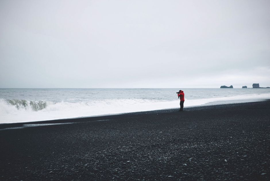 Person in waterproof jacket on a windy Icelandic coast