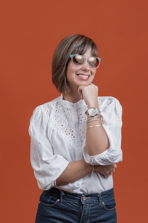 Woman in White Blouse Smiling on Camera