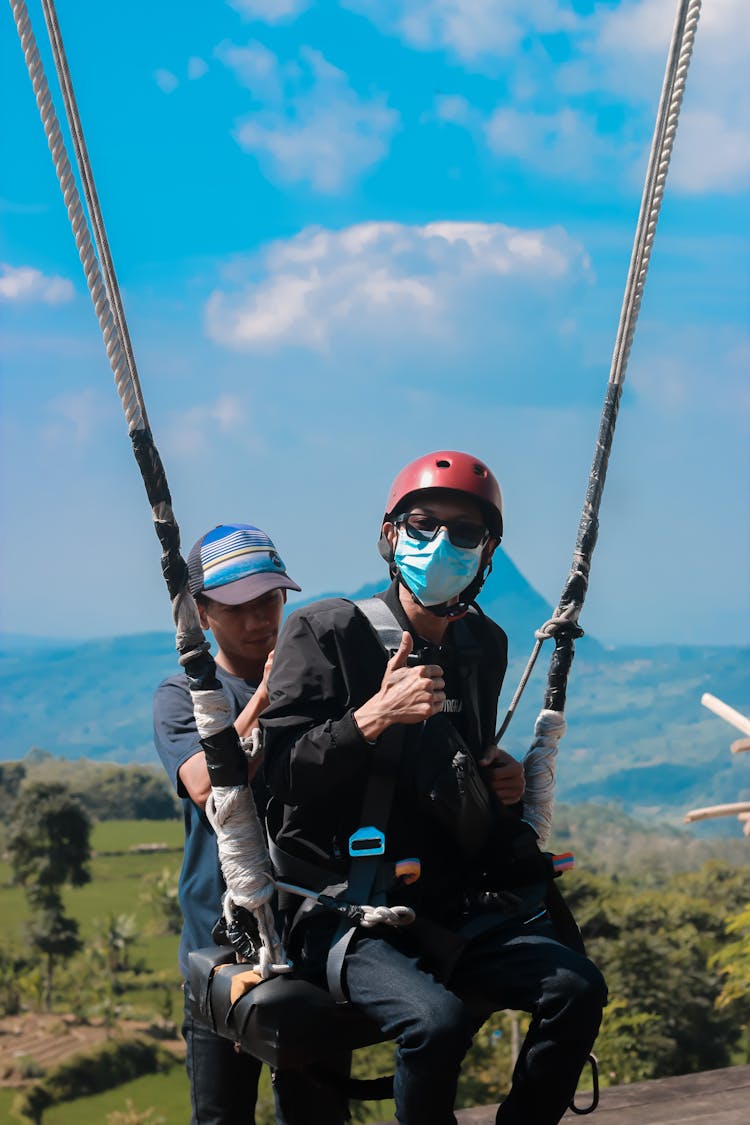 Person In Helmet On Ropes In Air