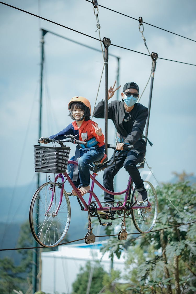 A Child And A Person Riding Sky Bike In Bali, Indonesia