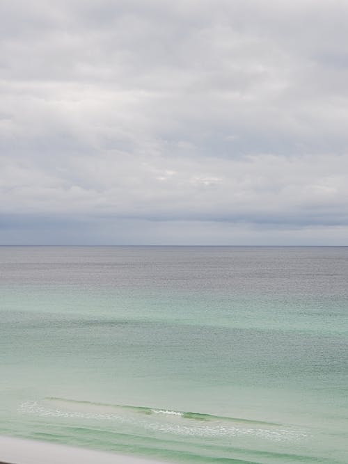 Free The Sea Under a Cloudy Sky Stock Photo