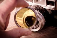 Person Holding Camera Lens