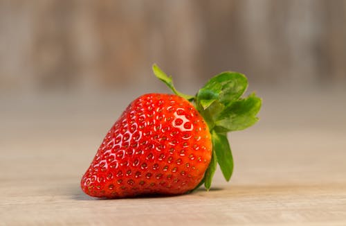 Free Strawberry Fruit on Brown Wooden Surface Stock Photo