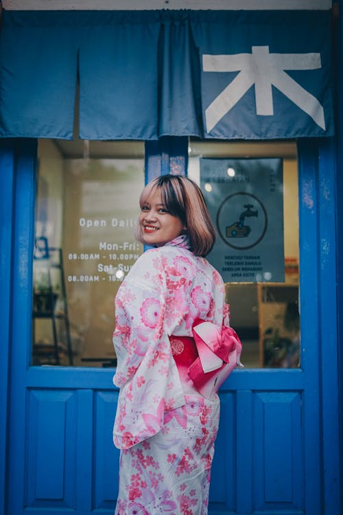 Woman in a White and Pink Kimono Dress Looking Over Her Shoulder