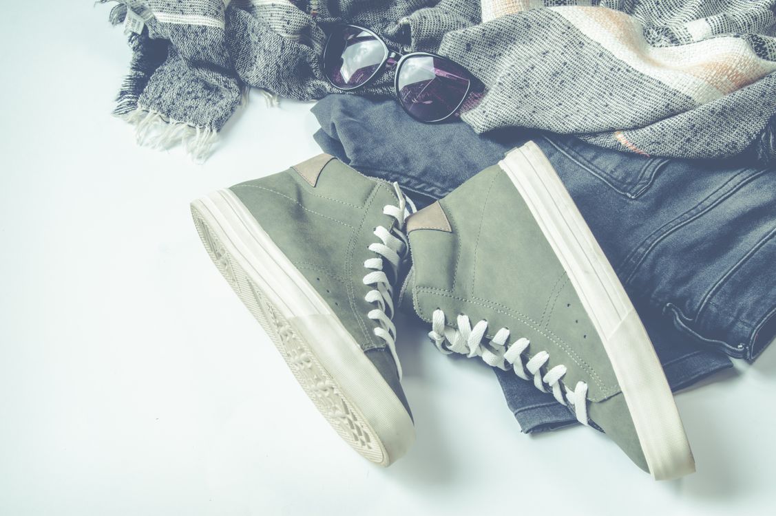 Free Green High-top Sneakers Beside Bottoms And Sunglasses Stock Photo