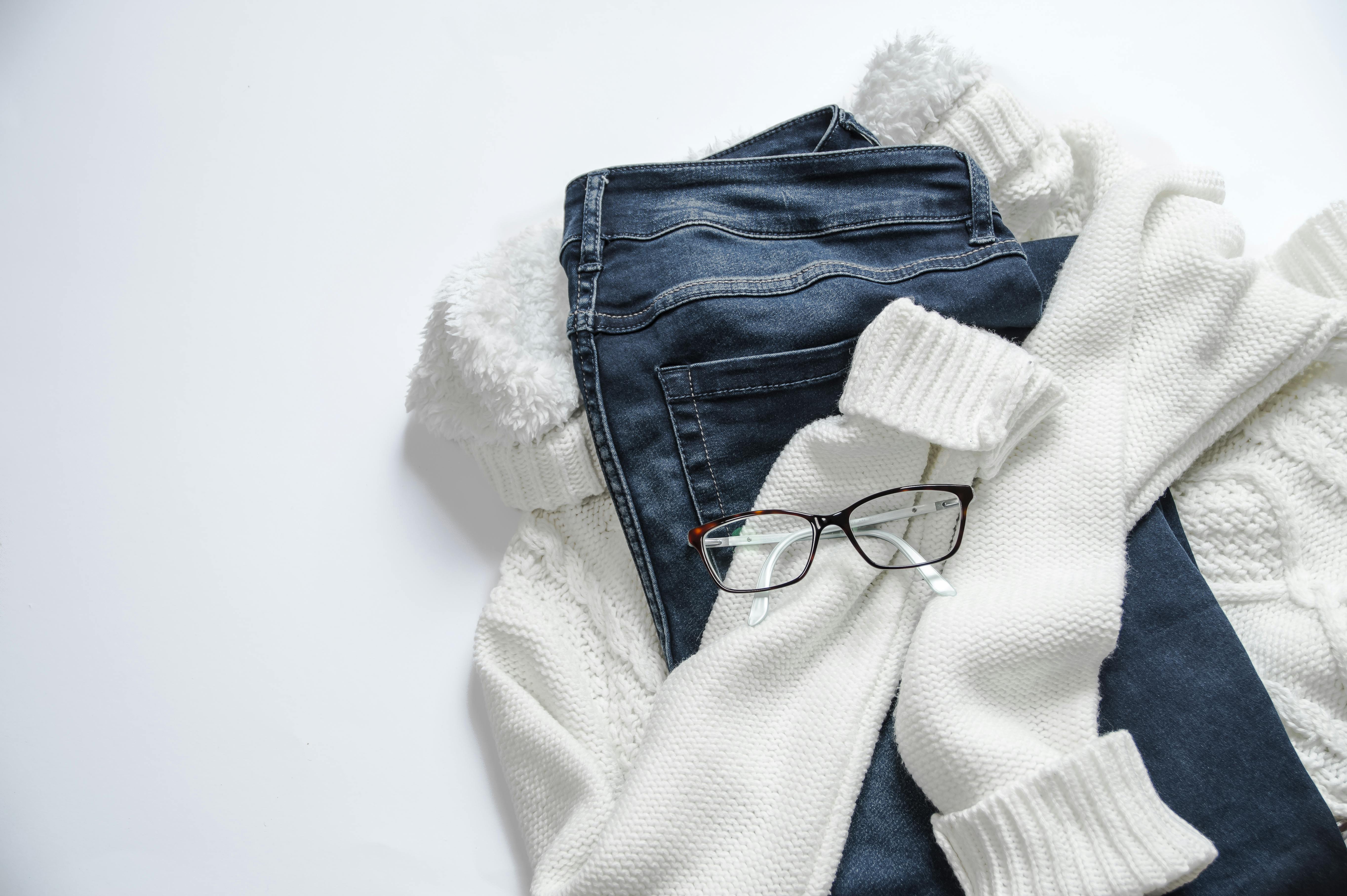 Glasses on a white jacket and blue jeans