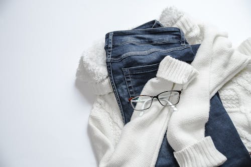 Free Black Framed Eyeglasses On White Jacket And Blue Denim Bottoms Stock Photo