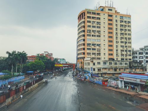 Free A vibrant street scene in Dhaka showcasing urban architecture and everyday life. Stock Photo