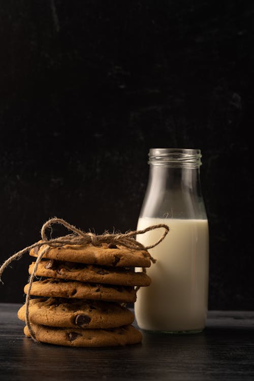 Free Close-Up Photo of a Stack of Cookies Beside a Glass Bottle of Milk Stock Photo