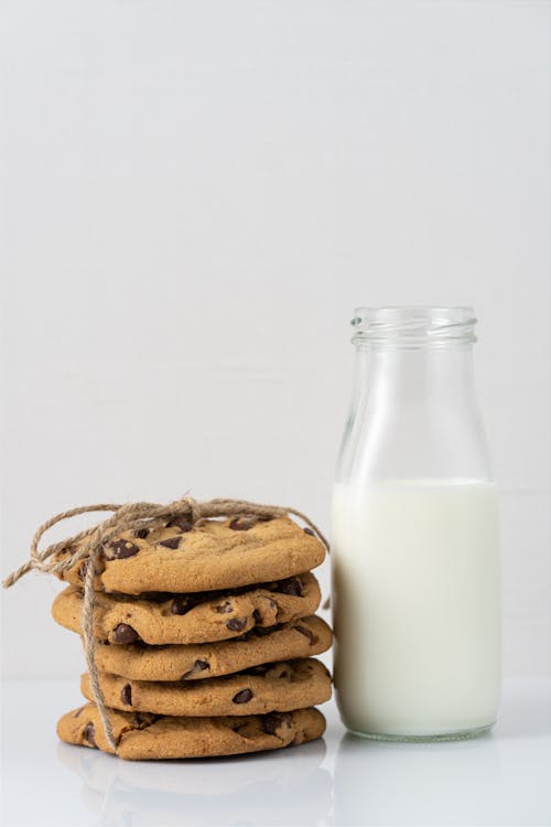 Free Photo of a Stack of Cookies and a Bottle of Milk  Stock Photo