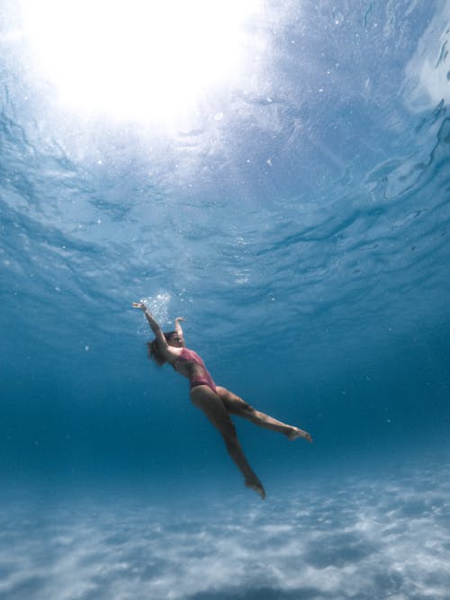 Free Woman in Blue Bikini Swimming in Water Stock Photo