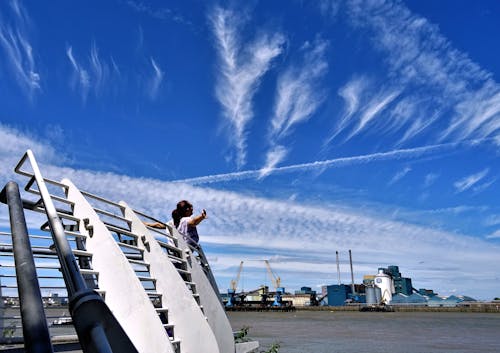 Woman Standing on Front of Gray Barriers