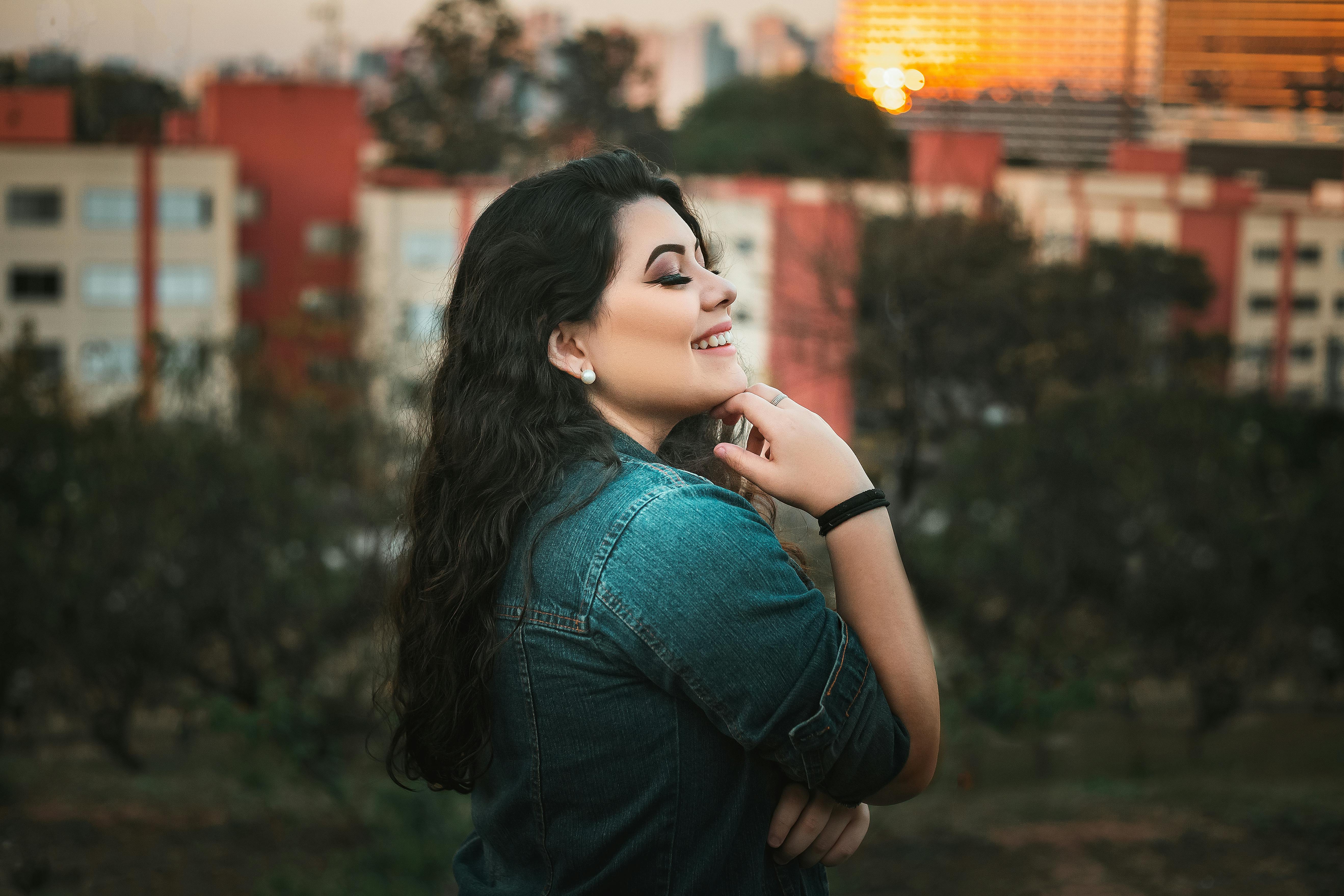 beautiful woman in blue denim jacket smiling