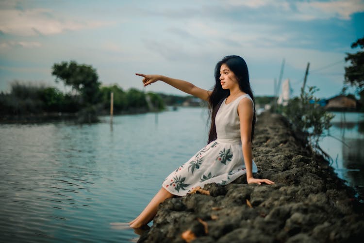 Woman In Dress On Riverbank