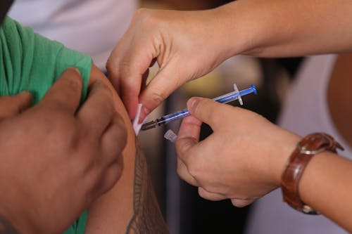 Free Close-up Photo of Injecting of Medicine on a Person  Stock Photo