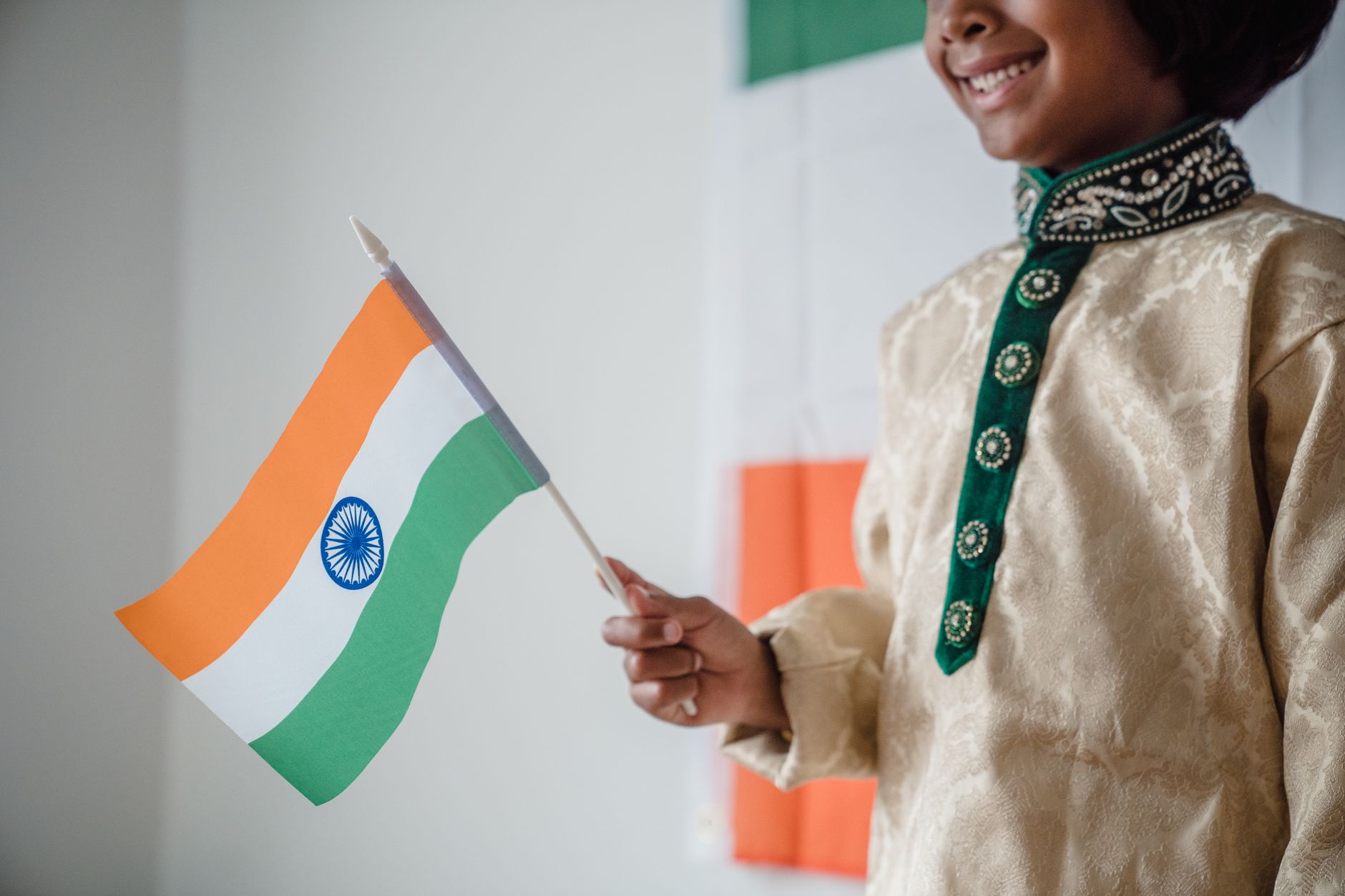 Indian supporters holding national flags outside a stadium after a dramatic cricket match, joyful crowded evening