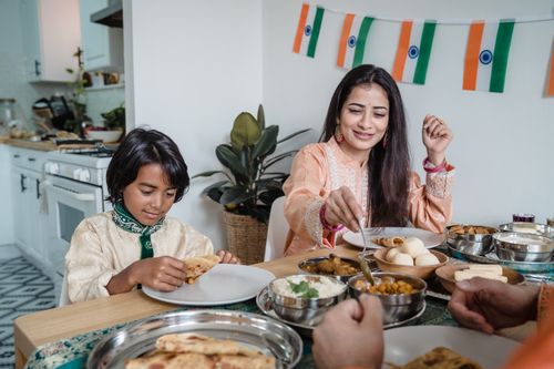 Indian mother and son enjoying a traditional meal together at home
