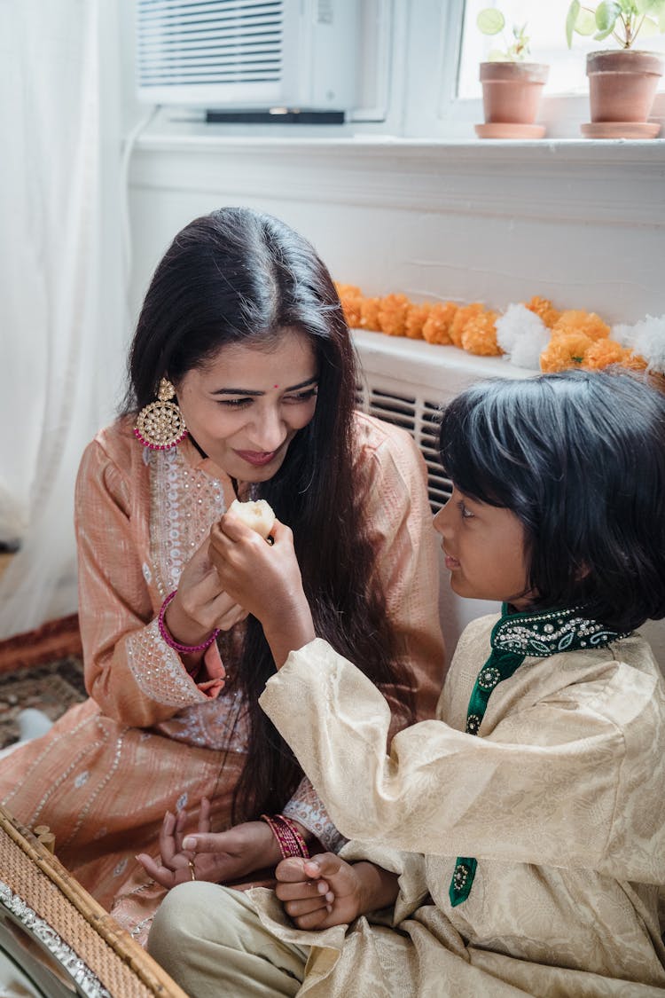 A Son Sharing Food With His Mother