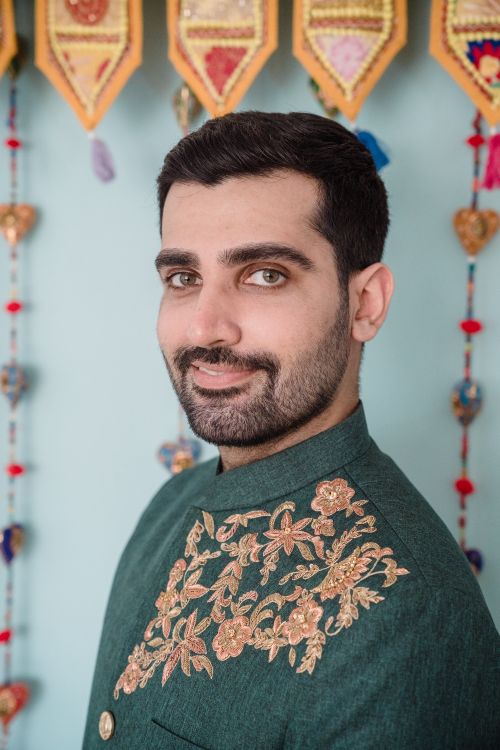 Free Portrait of a smiling man in traditional Indian attire, showcasing cultural elegance indoors. Stock Photo